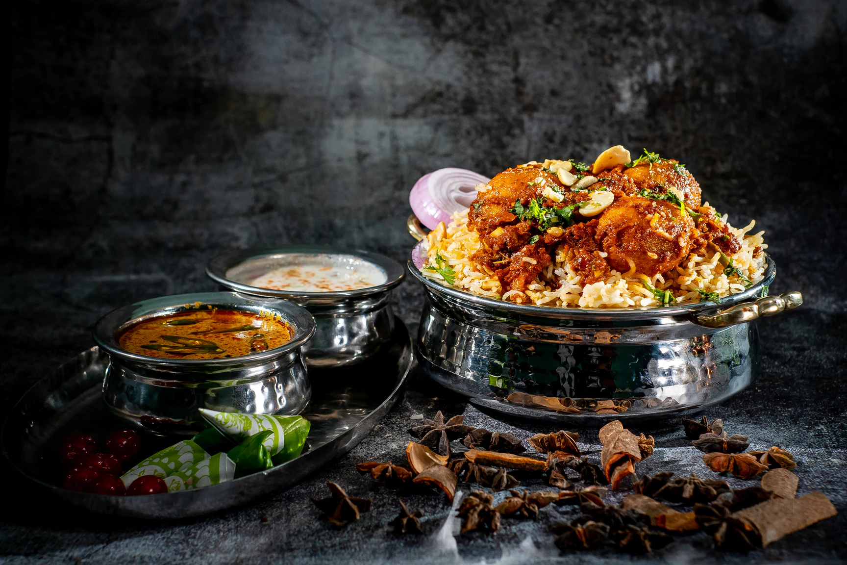 Copper handi of slow-cooked biryani being opened